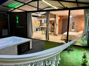 a hammock in a room with a bedroom and a bed at Cabaña el Anhelo Calma in Ginebra