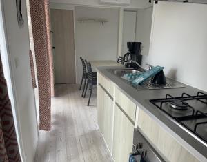 a kitchen with a sink and a stove top oven at rouge gorge in Valras-Plage +2 photos