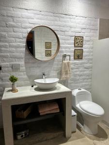 a bathroom with a sink and a toilet and a mirror at Cabaña el Anhelo Calma in Ginebra +11 photos