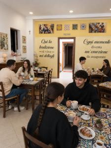 a group of people sitting at tables in a restaurant at B&B Gi-Rosa Caltagirone in Caltagirone +88 photos