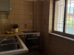 a kitchen with a sink and a window at Casa Glicine in Sperlonga +11 photos