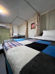 a bedroom with a large bed in a room at Sundays Hostel Sigiriya in Sigiriya