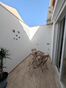 a room with a table and chairs on a balcony at Casas Albano 1 in Caldas da Rainha