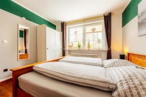 a bedroom with two beds and a window at Altes Forsthaus Königskrug in Braunlage