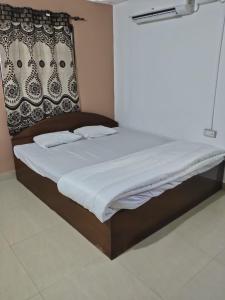 a large bed in a bedroom with avertisementatronatronatron at Flobestian's Seafront Villa in Candolim