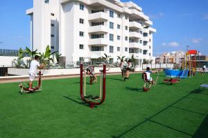 a group of people playing on an outdoor playground at La Loma in Águilas