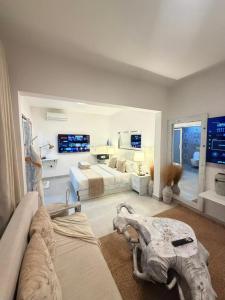 a large living room with two beds and a room with at 2 Bedroom en-suite studios by The Prime Escape in Arusha