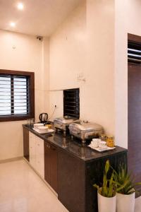 a kitchen with a black counter top in a room at Shri Radha Kunj Vrindavan in Vrindāvan