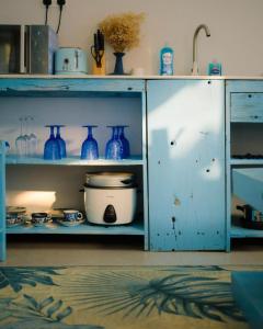a blue cabinet with blue vases on it at 2 Bedroom en-suite studios by The Prime Escape in Arusha +56 photos