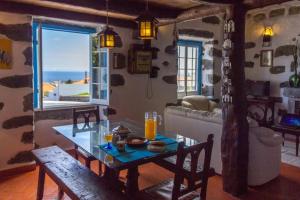 a living room with a table and a window at Casa Santa in Ribeira Grande +55 photos