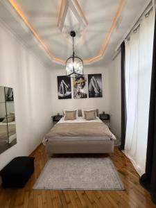 a bedroom with a bed and a chandelier at The sweet room in Ganja