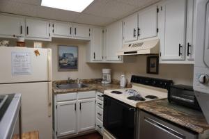 a kitchen with white cabinets and a stove top oven at River Place Condos #508 2BD in Pigeon Forge