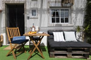 a table and a couch and a table and a chair at Sesimbra Cozy House BBQ & Terrace - MADA HOUSE's in Sesimbra +47 photos