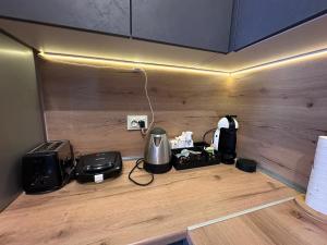 a kitchen with a counter with a stove and appliances at Alenik Private Apartment -Pamporovo in Pamporovo