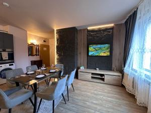 a dining room with a table and chairs at Alenik Private Apartment -Pamporovo in Pamporovo +30 photos