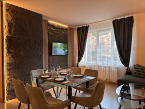a dining room with a table and chairs at Alenik Private Apartment -Pamporovo in Pamporovo