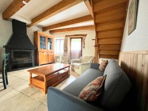 a living room with a couch and a fireplace at Gîtes de Rouvignac in Avène