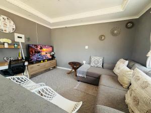 a living room with a couch and a tv at The Valley View Nest in Ezulwini +11 photos