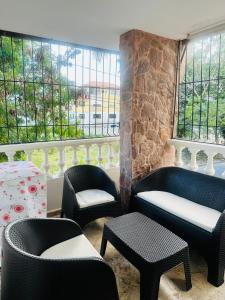 a room with chairs and tables and windows at Papagayo in Bayahibe