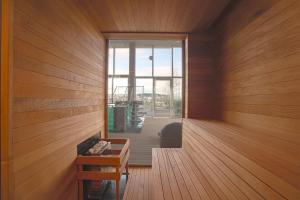 a room with wood paneled walls and a wooden floor at Suryaa Hotel Pinhais, Curio Collection by Hilton in Pinhais