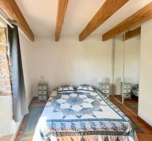 a bedroom with a bed and two night stands at Gîtes de Rouvignac in Avène