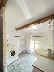 a bathroom with a sink and a washing machine at Gîtes de Rouvignac in Avène +74 photos
