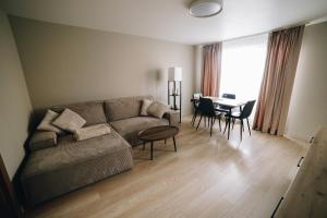 a living room with a couch and a table at MD Apartment in Rēzekne