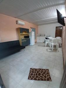 a room with a kitchen and a table and chairs at Olivia in Paysandú +9 photos