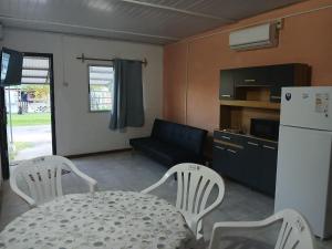 a living room with a table and chairs and a refrigerator at Olivia in Paysandú