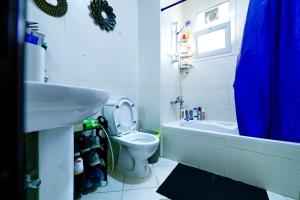 a bathroom with a toilet and a sink and a tub at Studio - Private - Abu Dhabi in Abu Dhabi