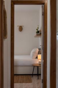 a small bedroom with a bed and a table at Sesimbra Cozy House BBQ & Terrace - MADA HOUSE's in Sesimbra