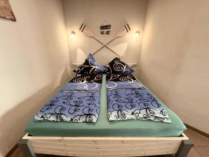 a bed with pillows on it in a room at L&L Skaters Home in Langenlipsdorf