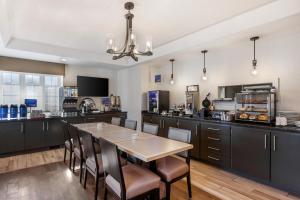 a large kitchen with a table and chairs at Best Western Colonel Butler Inn in Niagara-on-the-Lake
