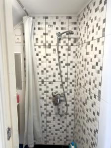 a shower with a shower curtain in a bathroom at Anchor House in Câmara de Lobos +22 photos