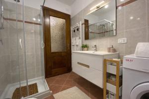 a bathroom with a shower and a sink and a toilet at Casa Elisa in Onore