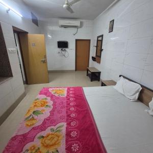 a room with a bed with a pink blanket on it at Sky Desert Safari With Swimming Pool in Jaisalmer