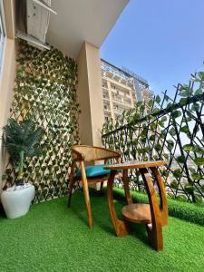 a patio with a bench and a table and chair at The Rudraya - Suites in Greater Noida