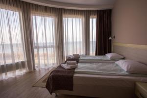 Un pat sau paturi într-o cameră la Hotel Zolotaya Milya