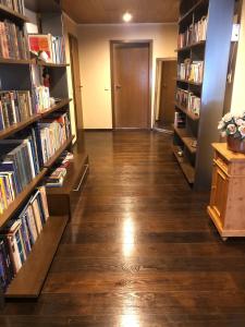 a hallway with bookshelves filled with books at Ferienwohnung Untersee in Öhningen