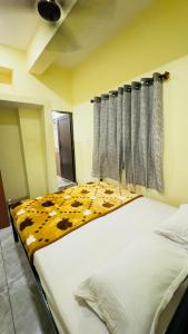a bedroom with a bed with a cow pattern on it at Delight rooms in Mysore