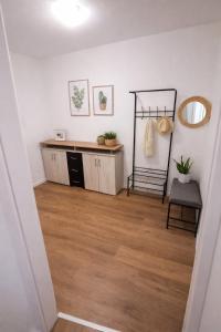 a living room with a wooden floor and a mirror at Appartment Okarben in Karben
