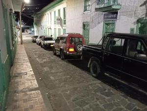 a couple of cars parked on the side of a street at Posada La Casona in El Cocuy +7 photos