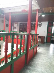 a red and green railing in a room at Posada La Casona in El Cocuy