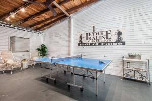 a ping pong table in a room with a wall at Opulent Expansive Unit Heated Pool and Spa in New Orleans