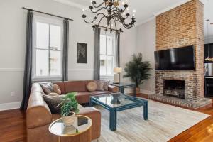 a living room with a couch and a fireplace at Opulent Expansive Unit Heated Pool and Spa in New Orleans