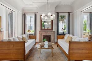 a living room with two white couches and a fireplace at Opulent Expansive Unit Heated Pool and Spa in New Orleans