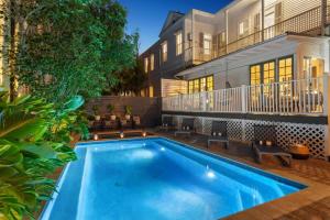 a swimming pool in front of a building at Opulent Expansive Unit Heated Pool and Spa in New Orleans +40 photos