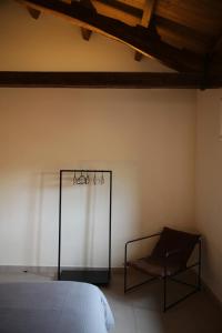 a bedroom with a bed and a chair at Casa Carmina Hostel in Muros de Nalón
