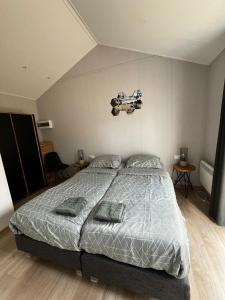 a bedroom with a bed with a guitar on the wall at Veluwe Retreat Inn Otterlo! in Otterlo