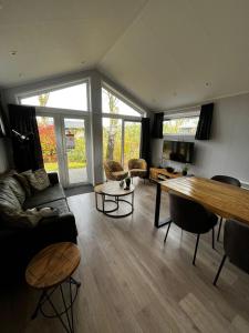 a living room with a couch and a table at Veluwe Retreat Inn Otterlo! in Otterlo